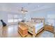 Spacious main bedroom with wood floors, ceiling fan, and a rustic wooden bed frame at 7274 Alan Blvd, Punta Gorda, FL 33982