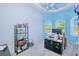 Bright home office features an unusual blue ceiling, modern fan, and great view of the property at 7274 Alan Blvd, Punta Gorda, FL 33982