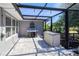Outdoor covered patio with grill, patio furniture and views of the property's green backyard at 7274 Alan Blvd, Punta Gorda, FL 33982