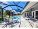 Screened pool enclosure with furniture and access to the house and views of the fenced backyard at 7274 Alan Blvd, Punta Gorda, FL 33982