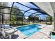 Enclosed pool with screened enclosure, outside lounge furniture and a view of the backyard at 7274 Alan Blvd, Punta Gorda, FL 33982