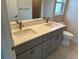 Modern bathroom featuring double sinks with chrome fixtures and gray cabinetry at 8667 Lisa Blvd, North Port, FL 34288