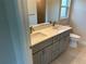 Modern bathroom featuring double sinks, gray cabinets, quartz countertops, and modern fixtures at 8667 Lisa Blvd, North Port, FL 34288