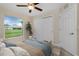 Bedroom featuring a bed, closet, and a window that offers a view of green grass and neighborhood at 8667 Lisa Blvd, North Port, FL 34288