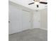 A bright bedroom with tiled floors, neutral paint, and large closet at 8667 Lisa Blvd, North Port, FL 34288