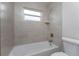 Bright bathroom featuring tile walls, shower, and modern fixtures at 8687 Lisa Blvd, North Port, FL 34288