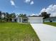Beautiful one-story home featuring a well-manicured lawn and a classic, neutral-toned facade at 8687 Lisa Blvd, North Port, FL 34288