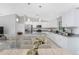 Bright kitchen featuring white cabinets, granite countertops, stainless steel appliances, and a large island at 8687 Lisa Blvd, North Port, FL 34288