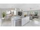 Open-concept kitchen featuring a granite island, modern lighting, and stainless steel appliances at 8687 Lisa Blvd, North Port, FL 34288