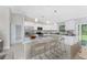 Spacious, open concept kitchen features an island with breakfast bar, stainless appliances, and modern finishes at 8687 Lisa Blvd, North Port, FL 34288