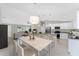 Bright, open kitchen featuring a large island, breakfast bar, stainless appliances and eat-in dining at 8687 Lisa Blvd, North Port, FL 34288