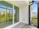 Screened-in back porch featuring stone flooring and a sliding glass door at 8700 Seasalt Loop, Englewood, FL 34224