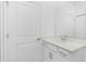 Bright bathroom features a white single sink vanity with modern fixtures and a large mirror at 8700 Seasalt Loop, Englewood, FL 34224