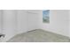 A bright bedroom featuring a window and double-door closet at 8700 Seasalt Loop, Englewood, FL 34224