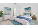 Bright bedroom showcasing modern decor, blue accents, and beach-themed art at 8700 Seasalt Loop, Englewood, FL 34224