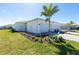 New construction home featuring a landscaped yard, white exterior, and attached two-car garage at 8700 Seasalt Loop, Englewood, FL 34224