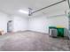 Spacious garage interior showing a water heater, doorway and ample storage space at 8700 Seasalt Loop, Englewood, FL 34224