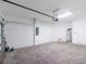 Garage interior featuring a water heater and a doorway on the back wall at 8700 Seasalt Loop, Englewood, FL 34224
