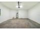 Garage interior featuring a water heater, doorway, and ample space at 8700 Seasalt Loop, Englewood, FL 34224
