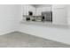 Open kitchen with stainless steel appliances and white cabinetry at 8700 Seasalt Loop, Englewood, FL 34224