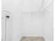 Empty walk-in closet with shelving ready to be customized for storage at 8700 Seasalt Loop, Englewood, FL 34224