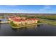 Beautiful aerial view of a condo complex surrounded by water, lush greenery and a residential area at 99 Vivante Blvd # 303, Punta Gorda, FL 33950