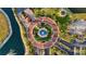 Aerial view of roundabout with a fountain, landscaping and mature trees in the Vivante community at 99 Vivante Blvd # 303, Punta Gorda, FL 33950