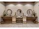 Bathroom featuring three sinks with decorative mirrors and fixtures at 99 Vivante Blvd # 303, Punta Gorda, FL 33950