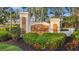 Elegant entrance sign for Vivante at Punta Gorda amidst lush landscaping and mature trees at 99 Vivante Blvd # 303, Punta Gorda, FL 33950