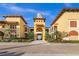 Attractive building exterior featuring a grand entrance with a tower and manicured landscaping at 99 Vivante Blvd # 303, Punta Gorda, FL 33950
