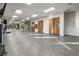 Bright fitness room featuring hardwood floors, mirrors, and ample open space at 99 Vivante Blvd # 303, Punta Gorda, FL 33950