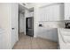 Bright kitchen features white cabinets, stainless steel appliances, and tile flooring at 99 Vivante Blvd # 303, Punta Gorda, FL 33950