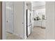 Modern kitchen features white cabinets and stainless steel appliances, seamlessly connected to the home at 99 Vivante Blvd # 303, Punta Gorda, FL 33950