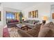Spacious living room offers comfortable seating, stylish decor, and access to the outdoors at 99 Vivante Blvd # 303, Punta Gorda, FL 33950