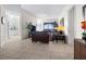 Open-concept living area with tile floors seamlessly connecting to the kitchen and outdoor balcony at 99 Vivante Blvd # 303, Punta Gorda, FL 33950