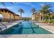 Inviting pool area with lounge chairs, palm trees and beautifully landscaped grounds at 99 Vivante Blvd # 303, Punta Gorda, FL 33950