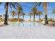 Relaxing pool area featuring lounge chairs, palm trees and elegant tile flooring in a tropical setting at 99 Vivante Blvd # 303, Punta Gorda, FL 33950
