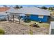 Aerial view of backyard, including pool, patio with seating, swing set, well-maintained lawn, and home exterior at 10229 Gulfstream Blvd, Englewood, FL 34224