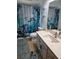 The bathroom is decorated with a whimsical turtle-themed shower curtain and matching artwork at 10229 Gulfstream Blvd, Englewood, FL 34224