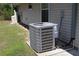 Side view of an outdoor residential air conditioning unit on a concrete pad next to home with neutral siding at 11422 2Nd Ave, Punta Gorda, FL 33955
