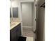 Stylish bathroom featuring a sleek vanity, decorative mirror, and modern fixtures plus wood look floors at 11422 2Nd Ave, Punta Gorda, FL 33955