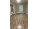 Bedroom with wood floor, a window, and a door at 11422 2Nd Ave, Punta Gorda, FL 33955
