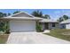 Charming single-Gathering home featuring a two-car garage, metal roof, and well-manicured front lawn at 11422 2Nd Ave, Punta Gorda, FL 33955