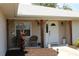 Inviting front porch featuring a decorative garden and a welcoming entrance to the home at 11422 2Nd Ave, Punta Gorda, FL 33955