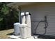 Exterior view of property's water system which include a water softener, holding tank, and filter system at 11422 2Nd Ave, Punta Gorda, FL 33955