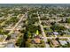 Scenic aerial shot of a lovely home by a canal in a quiet neighborhood with mature trees and lush landscaping at 1231 Beacon Dr, Port Charlotte, FL 33952