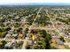 Lovely neighborhood aerial view showcasing the property surrounded by waterways, mature trees, and inviting landscaping at 1231 Beacon Dr, Port Charlotte, FL 33952