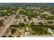 Expansive aerial view of a charming home nestled among lush trees with a long driveway and a canal in the neighborhood at 1231 Beacon Dr, Port Charlotte, FL 33952