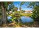 A cozy home featuring a well-maintained backyard, a scenic waterfront view with mature trees, offering a serene space at 1231 Beacon Dr, Port Charlotte, FL 33952