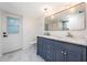 Bathroom with marble floors, a double sink vanity, a large mirror, and elegant pendant lighting at 1231 Beacon Dr, Port Charlotte, FL 33952